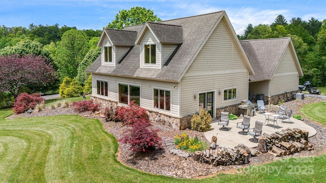 2912 Windswept Ridge Rd, Marshall, NC 28753 - rear view of property with stone siding, roof with shingles, a patio, and a lawn