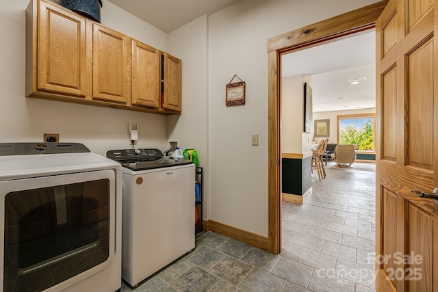 2912 Windswept Ridge Rd, Marshall, NC 28753 - clothes washing area with cabinet space, washer and clothes dryer, and baseboards
