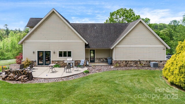 2912 Windswept Ridge Rd, Marshall, NC 28753 - rear view of house featuring central air condition unit, a lawn, a shingled roof, a patio area, and stone siding