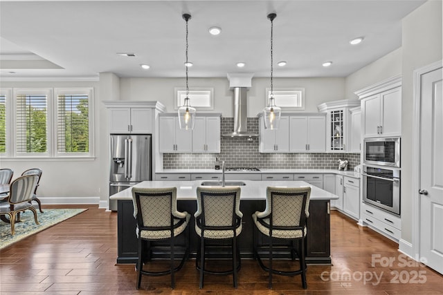 9750 Briarwick Ln, Charlotte, NC 28277 - kitchen featuring appliances with stainless steel finishes, wall chimney exhaust hood, healthy amount of natural light, light countertops, and recessed lighting