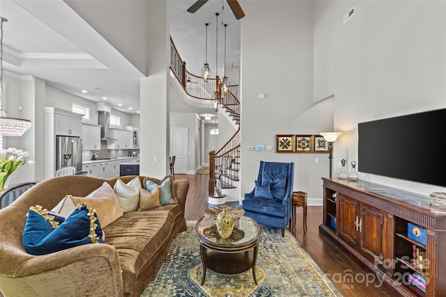 9750 Briarwick Ln, Charlotte, NC 28277 - living room featuring dark wood finished floors, a ceiling fan, stairway, baseboards, and a chandelier
