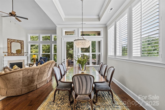 9750 Briarwick Ln, Charlotte, NC 28277 - dining space with a tray ceiling, wood-type flooring, plenty of natural light, a fireplace, and ornamental molding