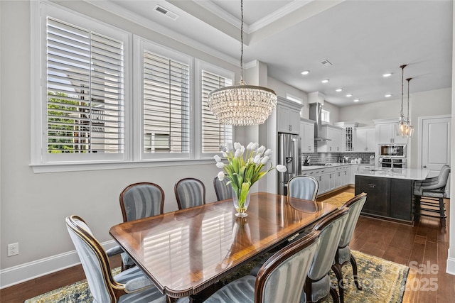9750 Briarwick Ln, Charlotte, NC 28277 - dining space featuring a chandelier, dark wood-style flooring, ornamental molding, baseboards, and recessed lighting