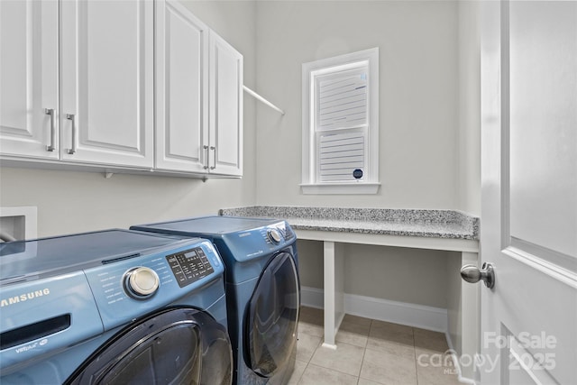 9750 Briarwick Ln, Charlotte, NC 28277 - laundry area featuring cabinet space, separate washer and dryer, light tile patterned floors, and baseboards