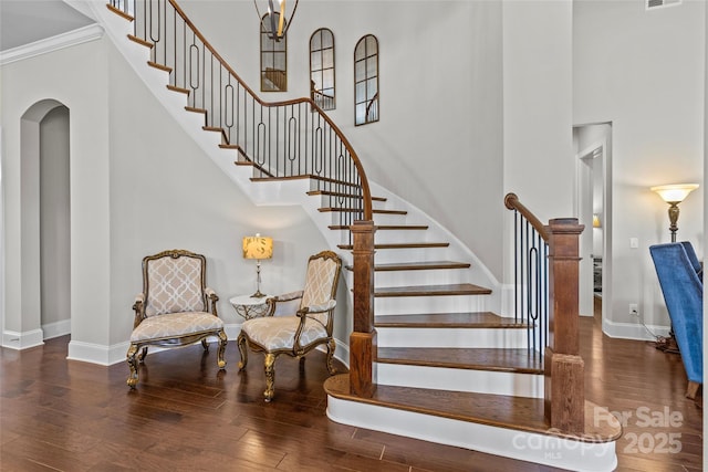 9750 Briarwick Ln, Charlotte, NC 28277 - stairway featuring baseboards, wood finished floors, a high ceiling, and ornamental molding