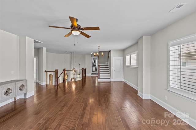 9750 Briarwick Ln, Charlotte, NC 28277 - unfurnished living room with a chandelier, a ceiling fan, baseboards, and wood finished floors