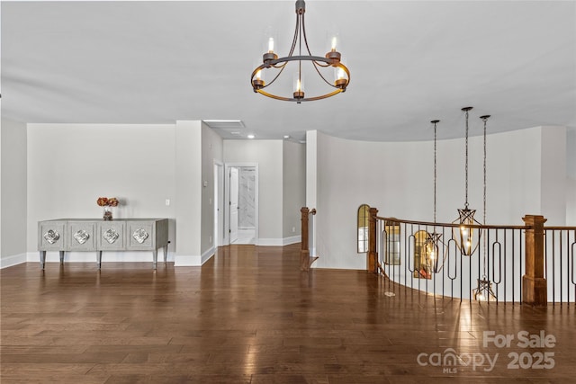 9750 Briarwick Ln, Charlotte, NC 28277 - spare room with a chandelier, wood-type flooring, and baseboards