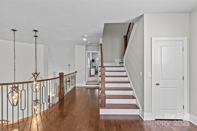 9750 Briarwick Ln, Charlotte, NC 28277 - stairs featuring a chandelier, hardwood / wood-style flooring, baseboards, and recessed lighting