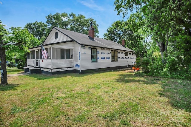 514 S Martin St, Shelby, NC 28150 - view of home's exterior with a sunroom, a chimney, and a lawn