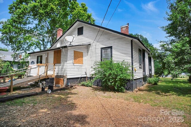 514 S Martin St, Shelby, NC 28150 - view of home's exterior with a chimney and central air condition unit