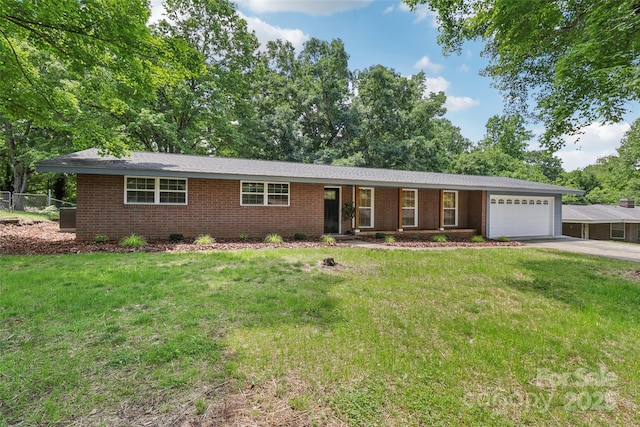 single story home featuring a garage, brick siding, and driveway