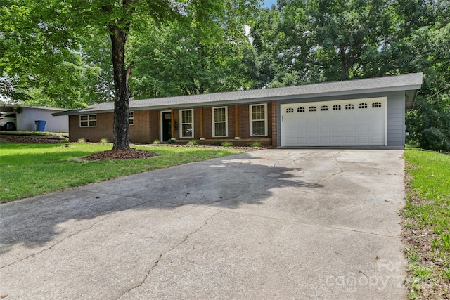 ranch-style home featuring driveway, a front yard, a garage, and brick siding