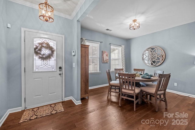 6119 Castlecove Rd, Charlotte, NC 28278 - dining area featuring a chandelier, dark wood-style flooring, baseboards, and crown molding