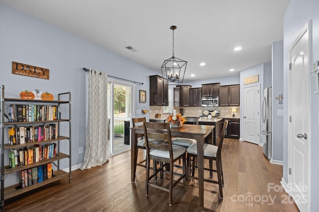 6119 Castlecove Rd, Charlotte, NC 28278 - dining area with dark wood-style floors, a chandelier, recessed lighting, and baseboards