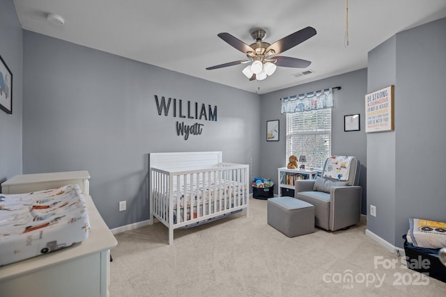 6119 Castlecove Rd, Charlotte, NC 28278 - bedroom featuring a crib, light carpet, ceiling fan, and baseboards