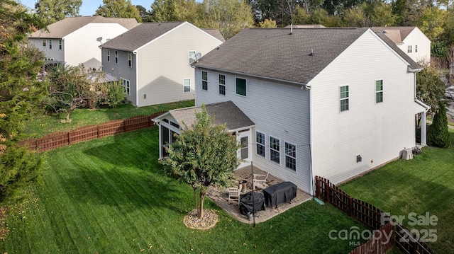 6119 Castlecove Rd, Charlotte, NC 28278 - back of house featuring a sunroom, roof with shingles, and a patio area