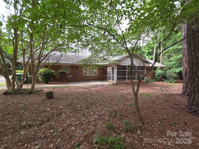 3316 Mckee Rd, Charlotte, NC 28270 - rear view of property with a sunroom, brick siding, and a patio area