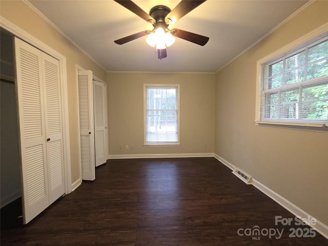 3316 Mckee Rd, Charlotte, NC 28270 - unfurnished bedroom with dark wood finished floors, ornamental molding, baseboards, two closets, and a ceiling fan