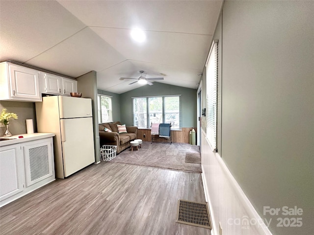 108 Sailors Ct Unit 108B, Mount Gilead, NC 27306 - living area with lofted ceiling, light wood finished floors, a ceiling fan, and a wainscoted wall