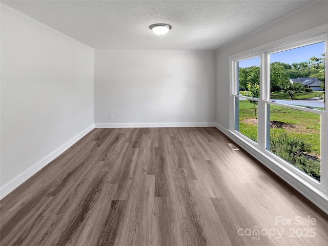 2532 Steeplechase Rd, Gastonia, NC 28056 - unfurnished room with wood finished floors, a textured ceiling, baseboards, and crown molding