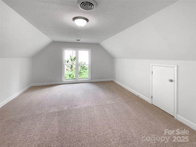 2532 Steeplechase Rd, Gastonia, NC 28056 - bonus room featuring baseboards, lofted ceiling, carpet, and a textured ceiling