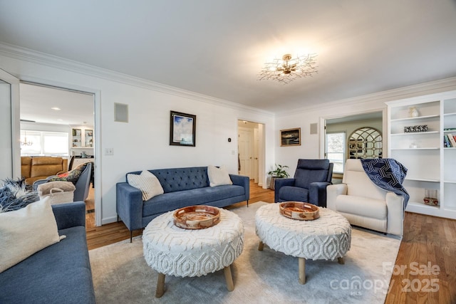 2702 Oxborough Dr, Matthews, NC 28105 - living room with plenty of natural light, ornamental molding, and wood finished floors