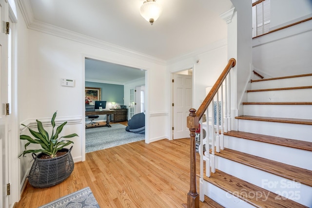 2702 Oxborough Dr, Matthews, NC 28105 - foyer entrance with crown molding, light wood finished floors, stairway, and wainscoting