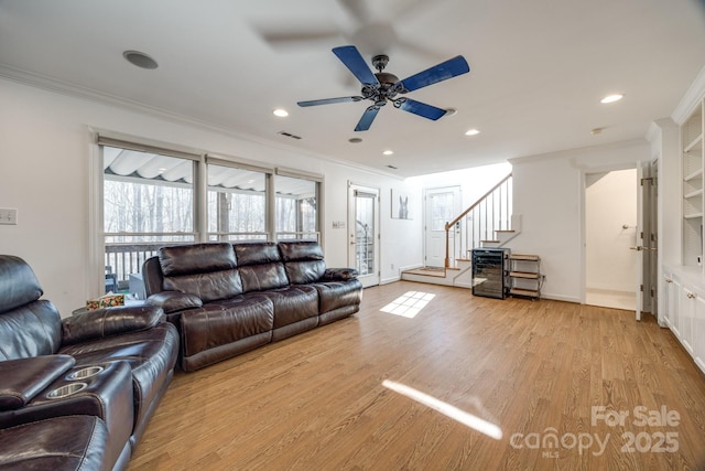 2702 Oxborough Dr, Matthews, NC 28105 - living area with ornamental molding, a ceiling fan, light wood-type flooring, stairway, and recessed lighting