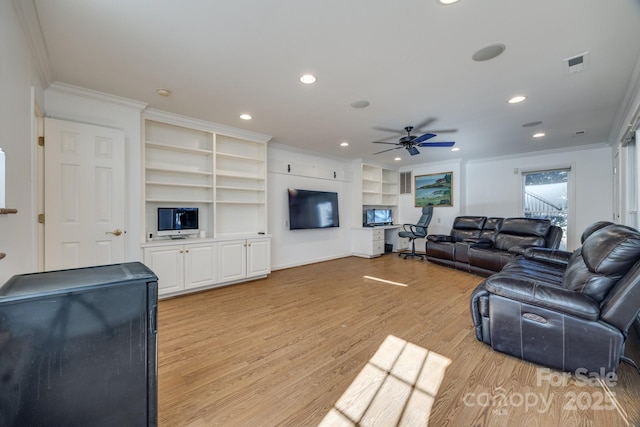 2702 Oxborough Dr, Matthews, NC 28105 - living room featuring crown molding, light wood finished floors, ceiling fan, built in features, and recessed lighting