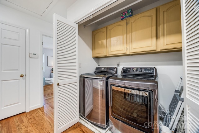 2702 Oxborough Dr, Matthews, NC 28105 - clothes washing area featuring cabinet space, washing machine and dryer, and light wood-style flooring