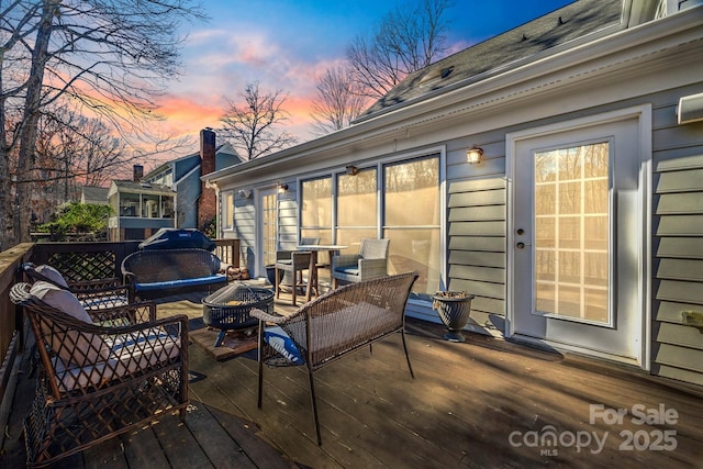 2702 Oxborough Dr, Matthews, NC 28105 - deck at dusk featuring an outdoor living space with a fire pit