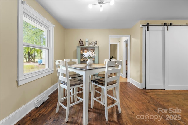 108 Greenwood Ave, Belmont, NC 28012 - dining space with baseboards, a barn door, and dark wood-style flooring
