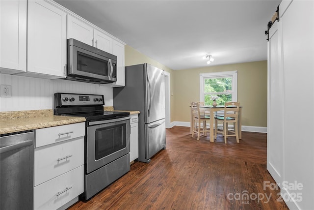 108 Greenwood Ave, Belmont, NC 28012 - kitchen with appliances with stainless steel finishes, dark wood-style flooring, white cabinetry, and baseboards