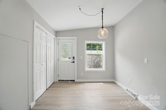 12382 Ritchie Rd, Midland, NC 28107 - foyer entrance featuring lofted ceiling, light wood-style flooring, and baseboards