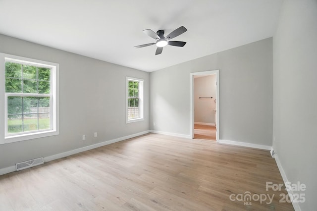 12382 Ritchie Rd, Midland, NC 28107 - empty room featuring healthy amount of natural light, a ceiling fan, baseboards, and light wood-type flooring