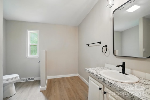 12382 Ritchie Rd, Midland, NC 28107 - half bathroom with wood finished floors, baseboards, vanity, and toilet