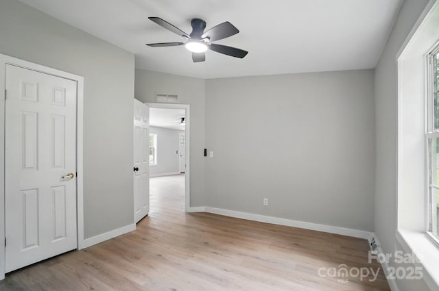12382 Ritchie Rd, Midland, NC 28107 - unfurnished bedroom featuring light wood-style floors, baseboards, and a ceiling fan