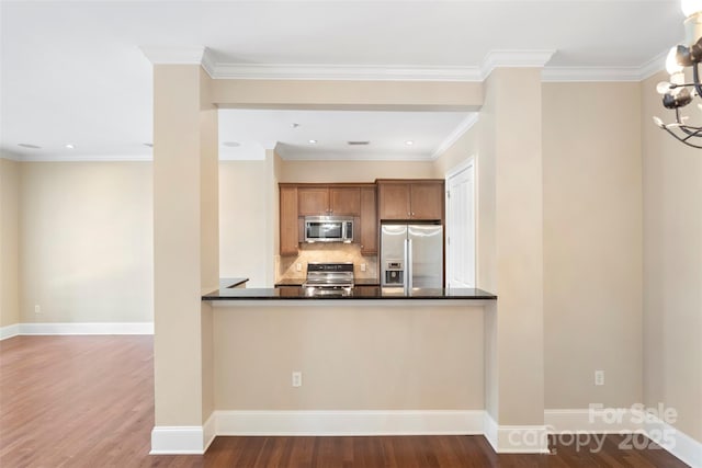 5425 Closeburn Rd Unit 208, Charlotte, NC 28210 - kitchen with stainless steel appliances, dark countertops, wood finished floors, decorative backsplash, and recessed lighting