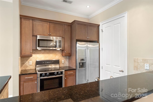 5425 Closeburn Rd Unit 208, Charlotte, NC 28210 - kitchen with appliances with stainless steel finishes, tasteful backsplash, dark stone countertops, ornamental molding, and brown cabinets