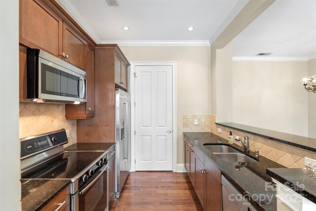 5425 Closeburn Rd Unit 208, Charlotte, NC 28210 - kitchen featuring stainless steel appliances, a sink, dark stone countertops, dark wood-type flooring, and crown molding
