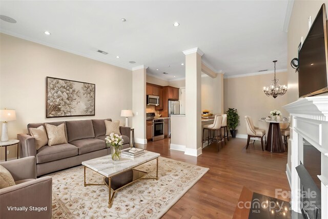 5425 Closeburn Rd Unit 208, Charlotte, NC 28210 - living room with wood finished floors, a chandelier, baseboards, ornamental molding, and recessed lighting