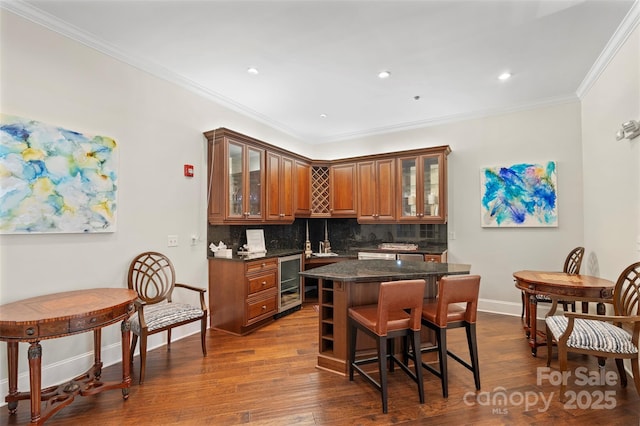 5425 Closeburn Rd Unit 208, Charlotte, NC 28210 - kitchen with beverage cooler, brown cabinetry, tasteful backsplash, a kitchen island, and a breakfast bar