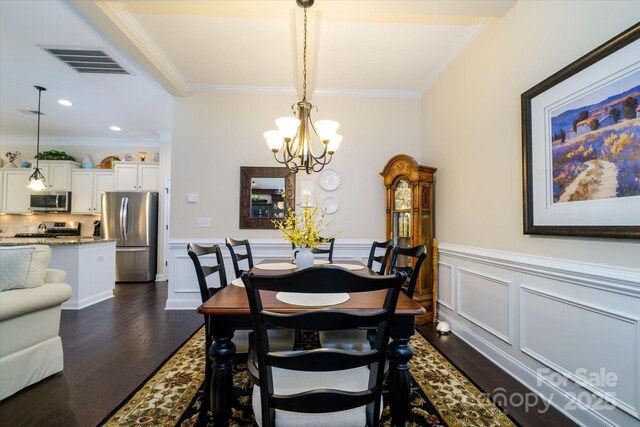 8818 Artesa Mill Ln, Charlotte, NC 28214 - dining room featuring a chandelier, dark wood-type flooring, crown molding, wainscoting, and recessed lighting