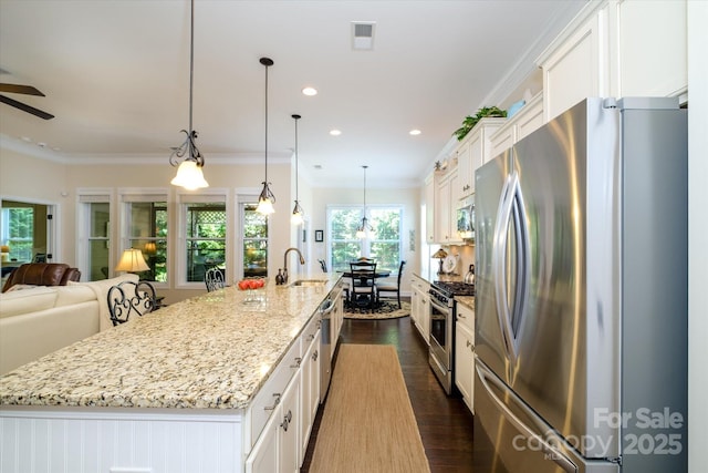 8818 Artesa Mill Ln, Charlotte, NC 28214 - kitchen with stainless steel appliances, a sink, open floor plan, white cabinetry, and a large island with sink