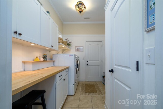 8818 Artesa Mill Ln, Charlotte, NC 28214 - laundry area with washing machine and clothes dryer, cabinet space, crown molding, and light tile patterned flooring