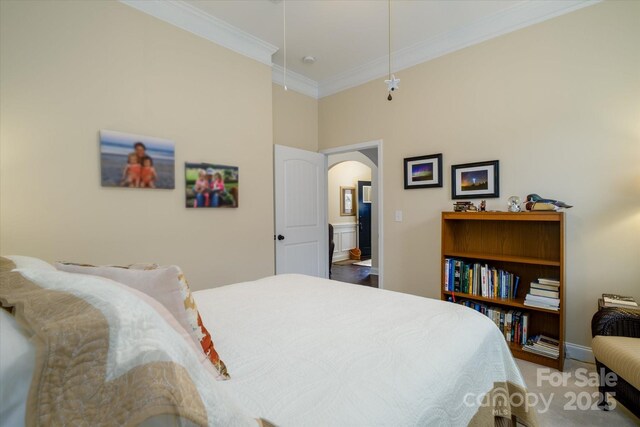 8818 Artesa Mill Ln, Charlotte, NC 28214 - carpeted bedroom featuring arched walkways, ornamental molding, baseboards, and attic access