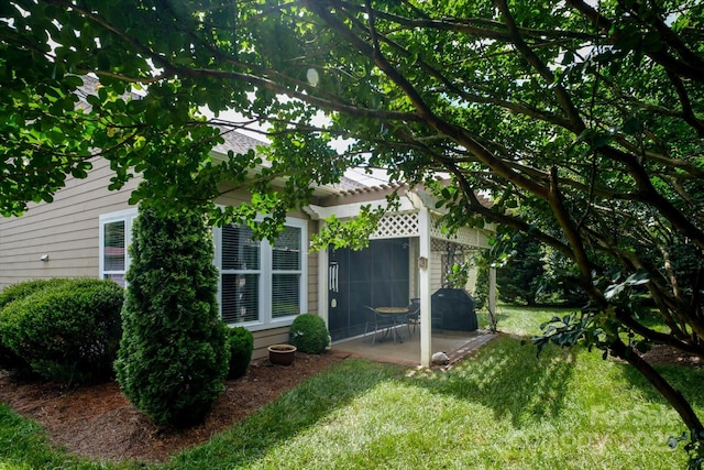 8818 Artesa Mill Ln, Charlotte, NC 28214 - view of home's exterior featuring a patio, a yard, and a pergola