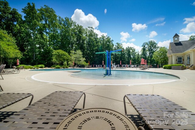8818 Artesa Mill Ln, Charlotte, NC 28214 - community pool with a patio area and view of scattered trees