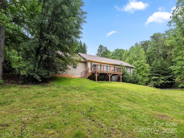 back of house with a wooden deck, a yard, and stairs
