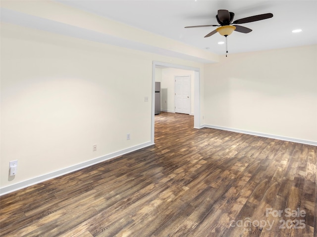 empty room with a ceiling fan, dark wood-type flooring, baseboards, and recessed lighting